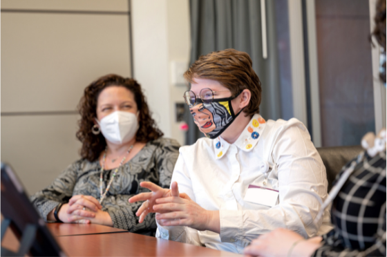 Doctors with masks meeting around a table