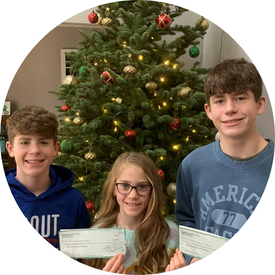 Owen and his siblings with checks from their fundraiser