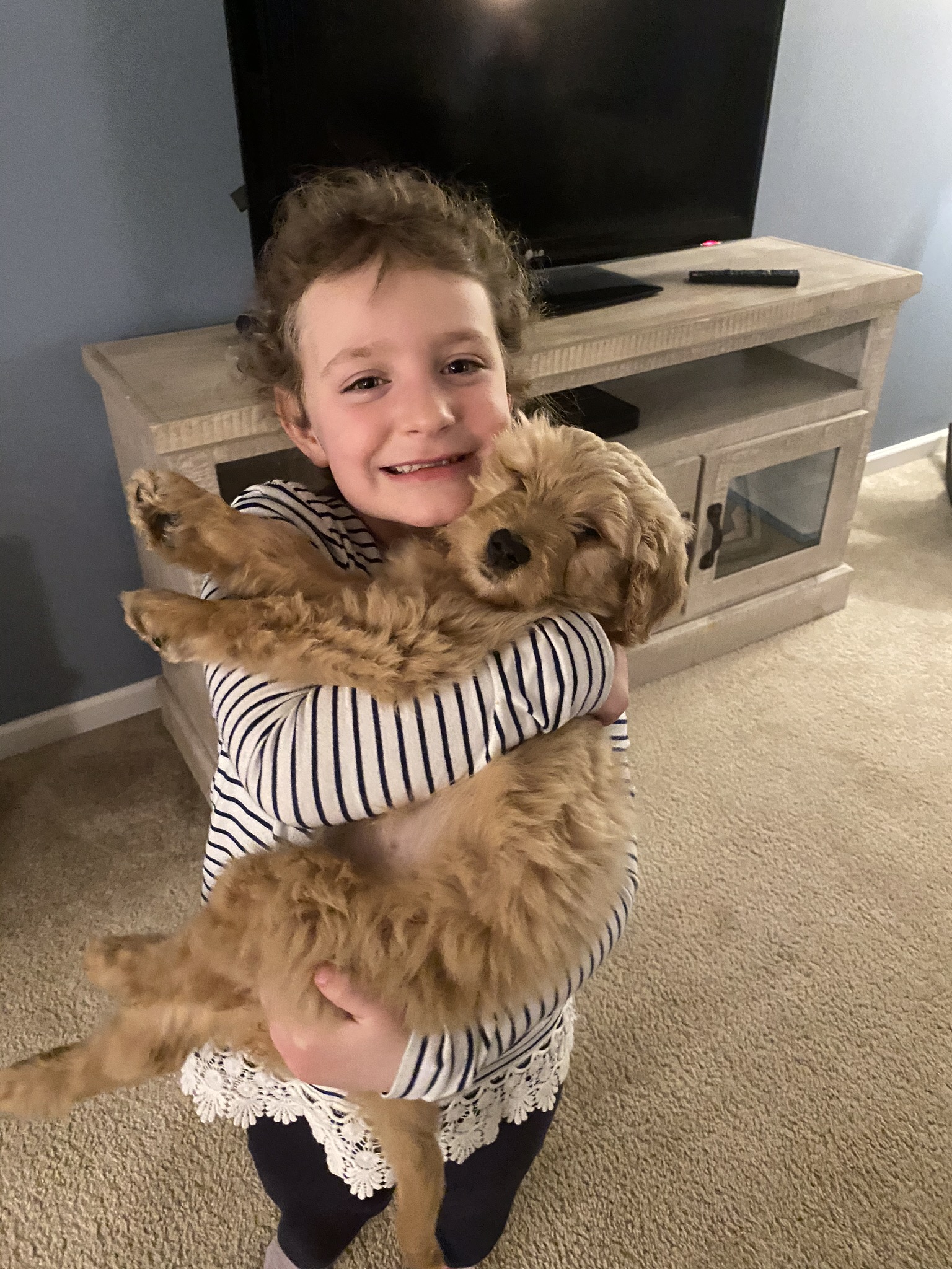 Girl smiling holding a dog